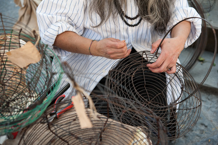 Basket weaving using thin iron yarnの写真素材