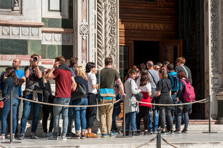 Florence, Italy - April 7, 2018: Tourists queue waiting at the entrance of Santa Maria del Fiore Cathedral, in Florence.のeditorial素材