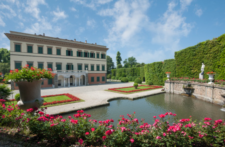 Marlia, Lucca, Italy - 2018, May 25: The Theatre of Water, with stone fountains, statues and beautiful roses flower beds. Villa Reale facade in the background.のeditorial素材