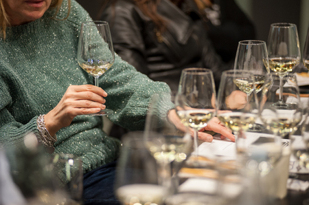 People tasting white wine during a masterclass.の写真素材
