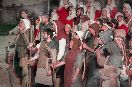 Unidentified participants during a historical reenactment. Group of poor medieval peasants during a...