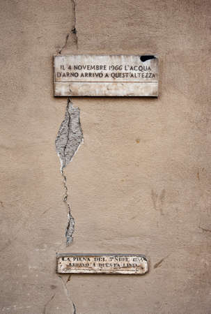 Florence, Italy - 2021, March 26: Memorial plaques commemorating the flood of the Arno in 1966, and the previous in 1844.のeditorial素材