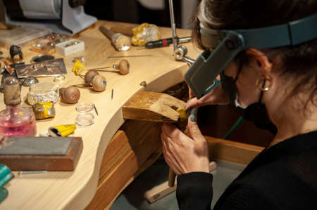 Goldsmith woman at work in his workshop. .