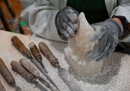 Working on alabaster sculpture. Various tools on the workbench.の写真素材