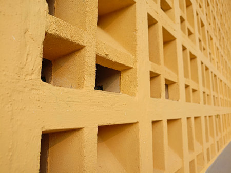 Decorative square shaped air vent wall, yellow concrete roster wall variationの写真素材