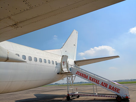 Surabaya, Indonesia - August 25, 2023 : Daytime view from the tail of the plane, stairs to the entrance of the plane in the airport parking lotのeditorial素材