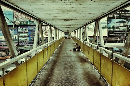 A beggar in overhead bridge found in Thailandのeditorial素材