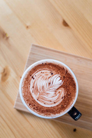 Hot chocolate nutella latte art on wood table.の写真素材