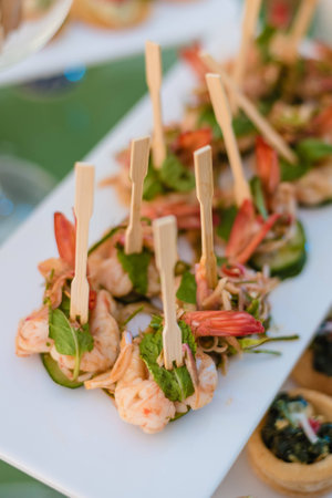 Snack prawn with basil leaf in party.