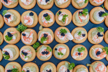 Appetizer canapes with shrimp on the black rock.の写真素材