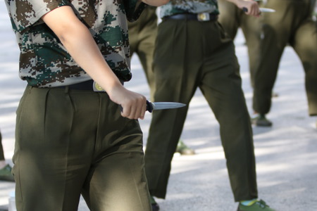 129 female Chinese students holding daggers take part in a military training at Zhengzhou University in Zhengzhou city, central China's Henan province, 8 September 2016. Freshmen will take compulsory military training in China's colleges.のeditorial素材