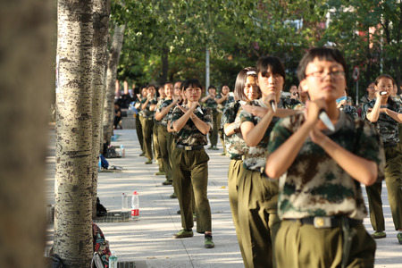 129 female Chinese students holding daggers take part in a military training at Zhengzhou University in Zhengzhou city, central China's Henan province, 8 September 2016. Freshmen will take compulsory military training in China's colleges.のeditorial素材