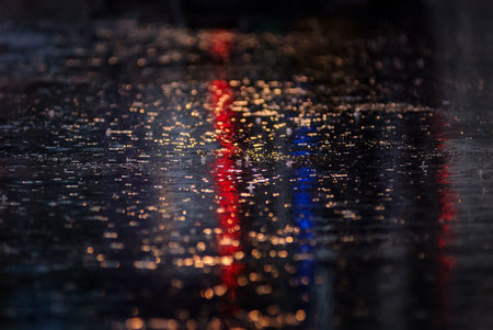 Water reflection on the road with colorful traffic light