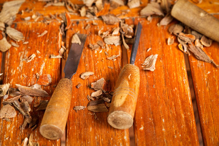 rasp and chisel , a carving tool on table with a piece of wooden cut