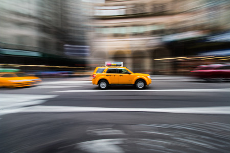 NEW YORK - AUG 16, 2015: Yellow taxi while crossing the Fifth Ave.のeditorial素材