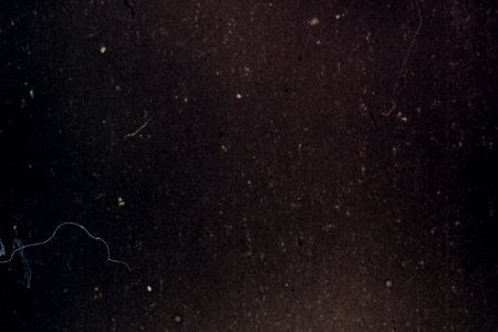 Dust scratches overlay. Distressed film texture. Worn effect layer. Purple blue green color stains grain particles noise on dark used surface illustration abstract background.の写真素材
