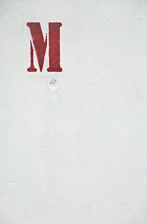 A letter M on a wall outdoorの写真素材