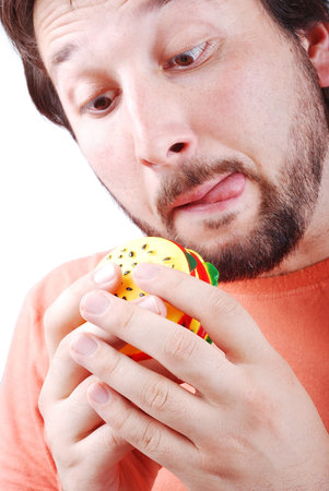 A young adult is about to eat a burger