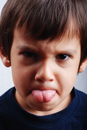 Kid with his tongue outside the mouth