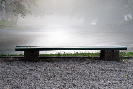A bench aside the river in morning time