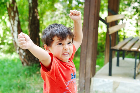 Cute little kid with angry expression on faceの写真素材