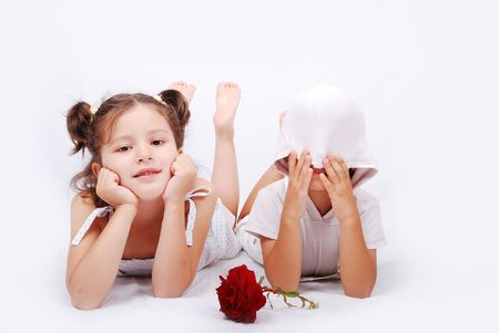 Beautiful scene of a girl and boy laying on groundの写真素材