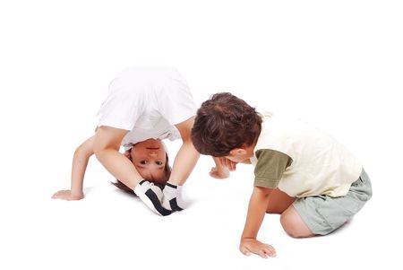 Two cute kids playing together isolated in whiteの写真素材