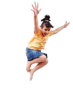 Happy cute girl in white clothes is jumping isolatedの写真素材