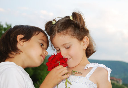 Beautiful scene of a boy and girl with roseの写真素材