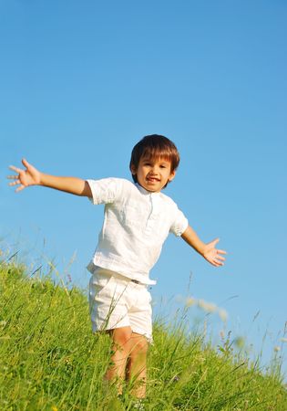 Happy unforgetable childhood on green meadow against blue skyの写真素材