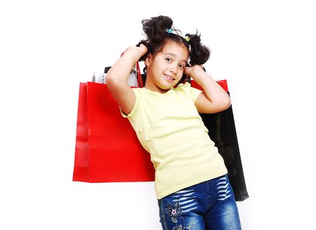 Cute little girl with bags for shoppingの写真素材