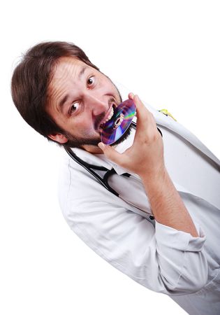 Young male doctor biting cdの写真素材