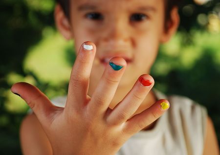 Several colors on children fingers, outdoorの写真素材