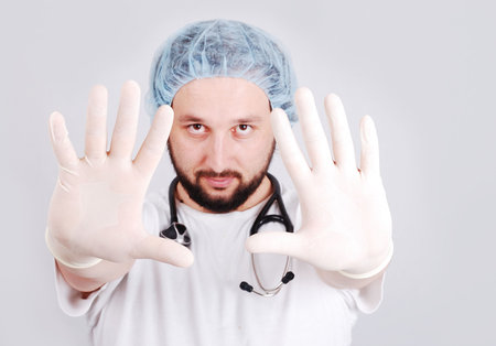 Young male doctor with hands in front and surgery gloves onの写真素材