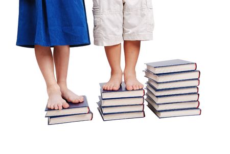 Little legs standing on books stairs, isolatedの写真素材