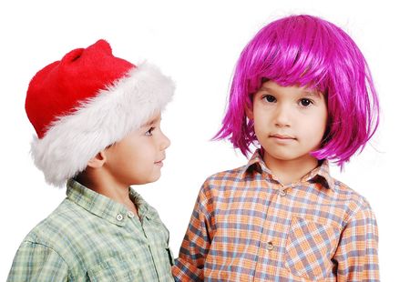Funny cute boy with pink periwig on head and santa boyの写真素材
