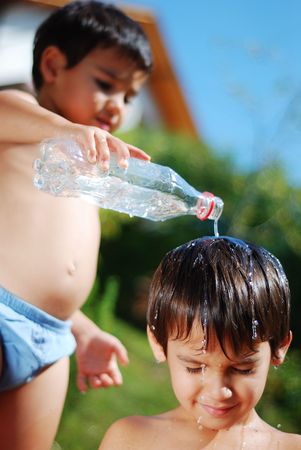 Very cute child playing with water outdoorの写真素材