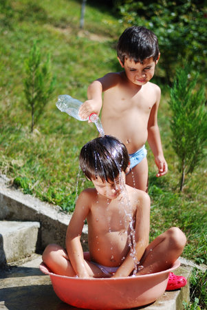 Very cute child playing with water outdoor