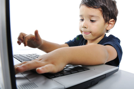 A little cute kid with a laptop isolated