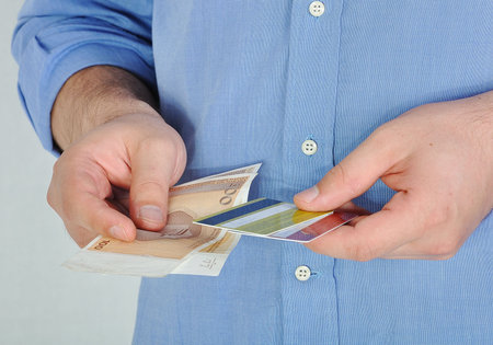 Young man with money and credit cardsの写真素材