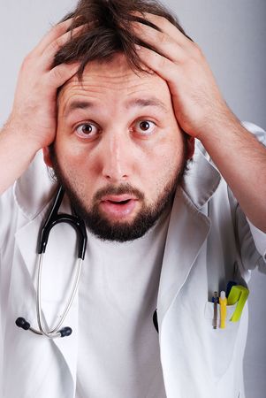 A male doctor with hands on headの写真素材