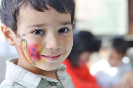 Positive kid with arts on his bodyの写真素材