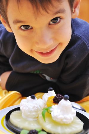 A little cute child with sweet dessertの写真素材