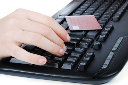 Female hands typing on credit card 