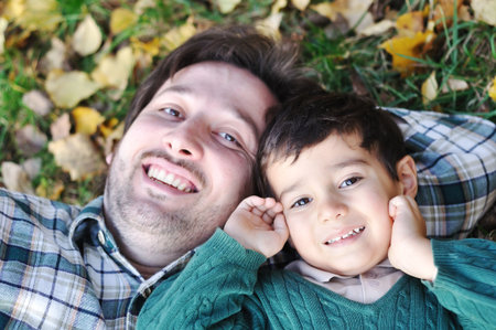 Happy father and son on ground 