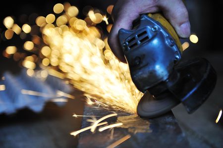 White hot sparks at grinding steel materialの写真素材