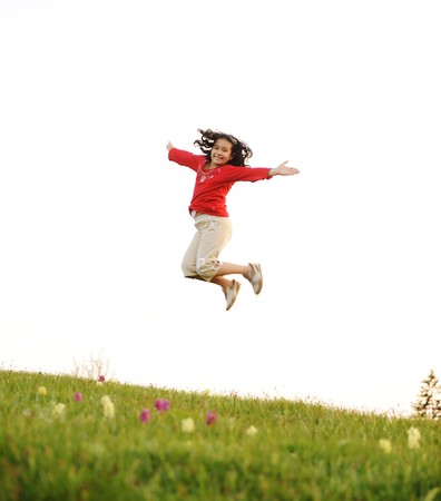 Happy acrobatic girl on meadowの写真素材