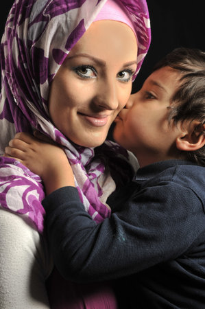 Muslim young woman with little cute kidの写真素材