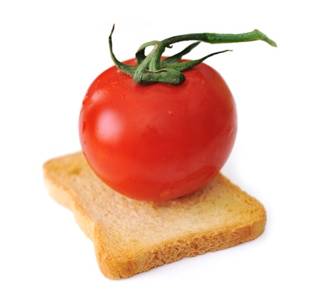 Tomato on slice of bread isolated, toast, vegetarian, vegetable, cerealの写真素材