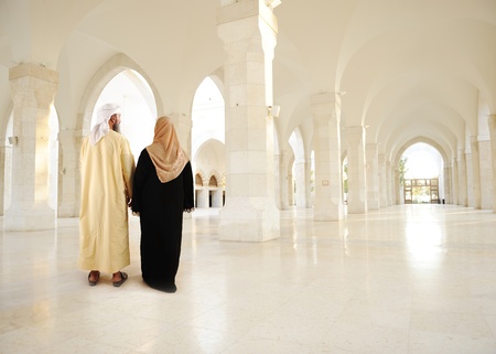 Muslim arabic couple inside big oriental empty modern buildingの写真素材